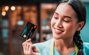 Lady holding premium rewards credit card