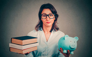Girl holding books and a piggy bank
