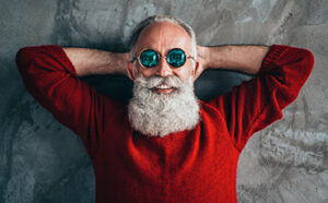 Santa Clause relaxing and wearing sunglasses