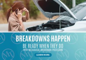 a woman with her head in her hand looking at a car with the hood open