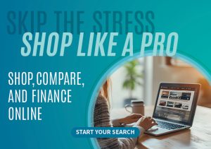 a woman sitting at a table using a laptop